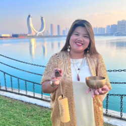 Somsanit-Phanthavong is a Certified Sophrologist (MISF) and Sound Healing Practitioner based in Doha, Qatar, where she runs Vivi Curvy Relaxation Center. Of French-Laotian heritage, she blends sophrology, sound bath practices and image consulting to help clients reconnect with calm and self-confidence. She is the author of L'Image Sacrée, an oracle deck, and is currently writing her second book exploring themes of displacement and belonging rooted in her family's history.